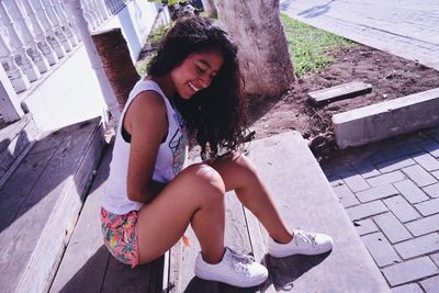 Smiling woman sitting on steps