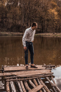 Rear view of man standing in lake