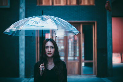 Portrait of beautiful woman standing in rain