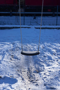 View of swing in snow
