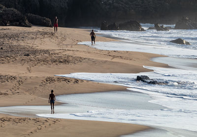 People standing on shore at beach