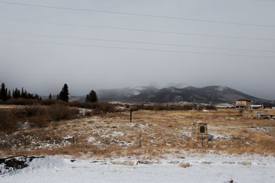 Scenic view of field and mountains against sky