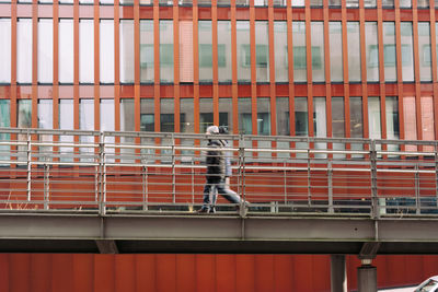 Man working on railing of building