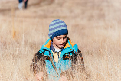 Boy on grassy field during winter