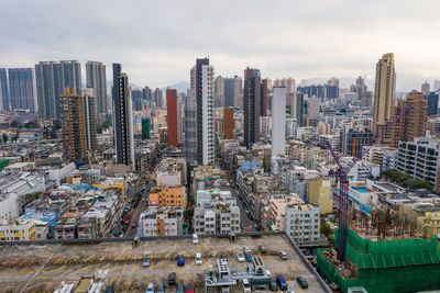 High angle view of buildings in city against sky