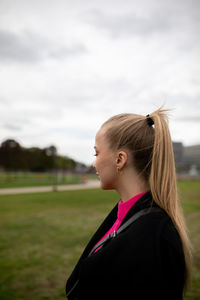 Portrait of girl on field against sky