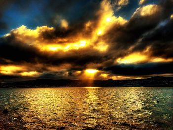 Scenic view of dramatic sky over sea during sunset