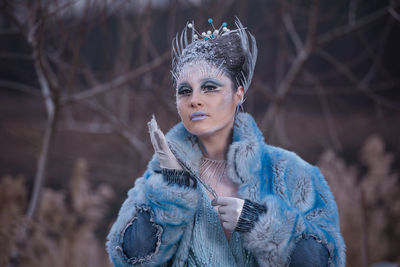 Portrait of woman wearing mask standing in winter