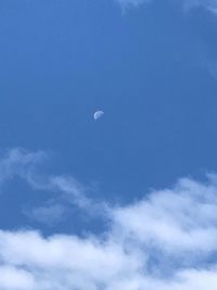 Low angle view of moon in blue sky