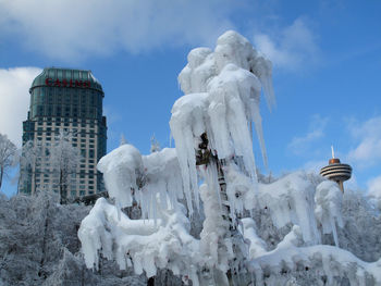 Low angle view of statue against sky during winter