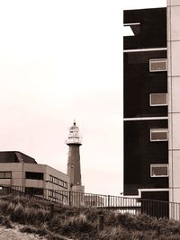 View of lighthouse against buildings