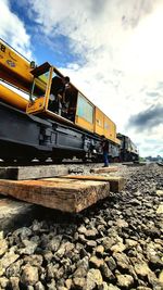 Train by railroad tracks against sky