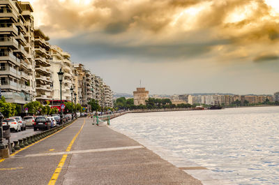 View of city buildings against cloudy sky