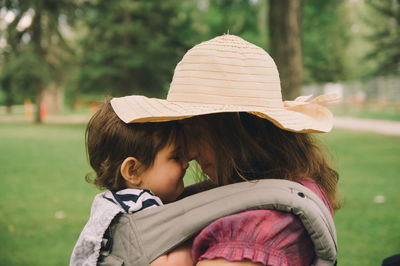 Close-up of mother and son embracing at park