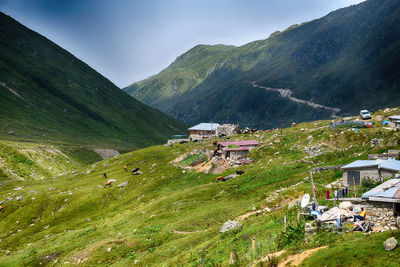 Scenic view of townscape and mountains against sky