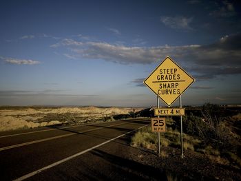 Information sign on road against sky