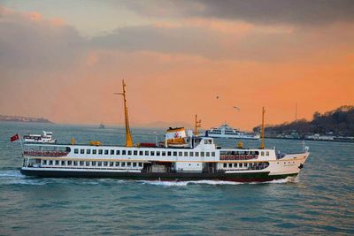 Boats sailing on sea against sky during sunset