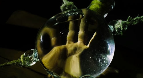 Close-up of drink glass against black background