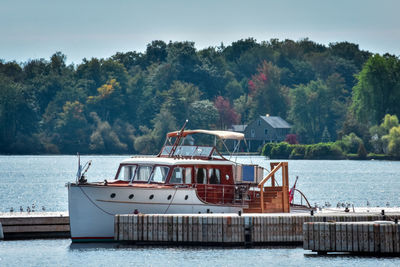 Classic yacht in the dock. lake ontario in autumn. colorful vivid trees. canada