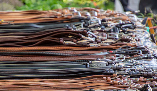 Stacked belts for sale at market stall