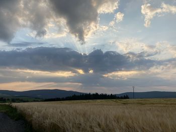 Scenic view of field against sky during sunset