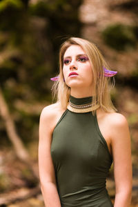 Portrait of beautiful young woman standing outdoors