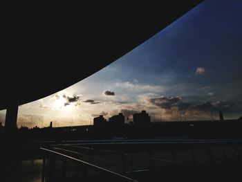 Silhouette city against sky during sunset