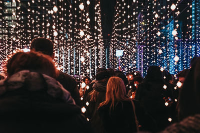 Rear view of people enjoying at music concert