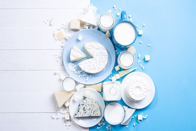 Dairy products on white wood and blue background with copy space. top view, flat lay.