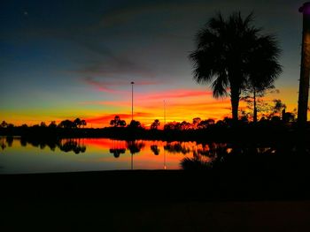 Silhouette palm trees against sky during sunset