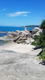 View of calm beach against blue sky