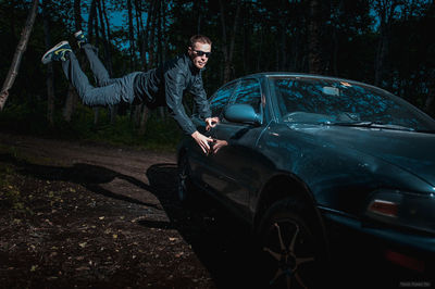 High angle view of man on car at night