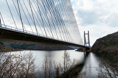 Modern suspension bridge across reservoir los barrios de luna in castile and leon, spain.