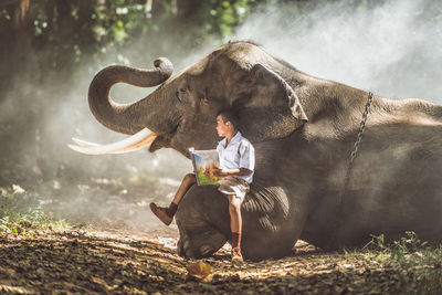 Full length of senior man sitting on land