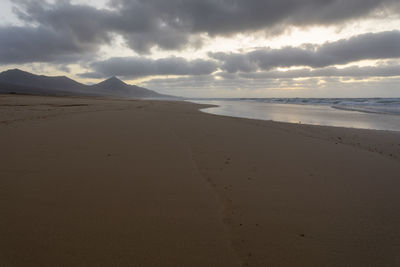 Scenic view of beach against sky during sunset