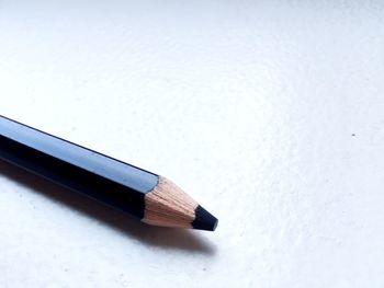 Close-up of black pencil on table