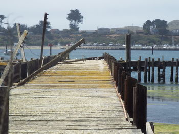 Wooden pier over lake against sky