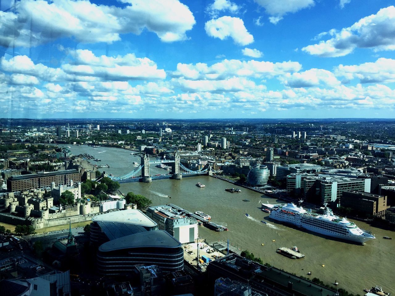 architecture, cityscape, built structure, building exterior, city, sky, water, high angle view, crowded, river, capital cities, cloud - sky, aerial view, residential district, travel destinations, city life, famous place, travel, sea, bridge - man made structure