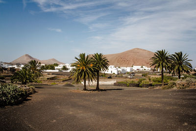 Scenic view of residential district against cloudy sky