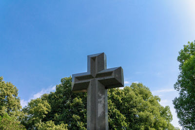 Low angle view of cross against clear blue sky