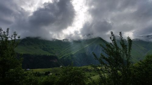 Scenic view of mountains against cloudy sky