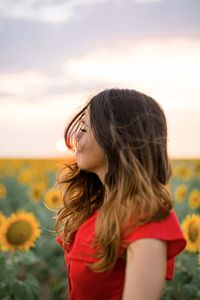 Portrait of beautiful woman against sky