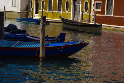 Boat moored on canal in city