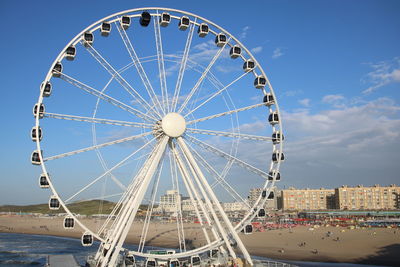 Low angle view of ferris wheel against beach