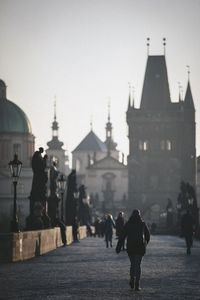 Group of people walking on street in city