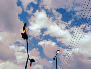 Low angle view of illuminated street light against sky