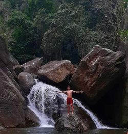 Man surfing on rock in forest