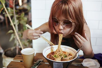 Girl eating noodles