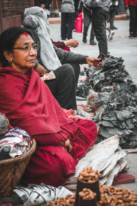 People sitting on street at market during winter