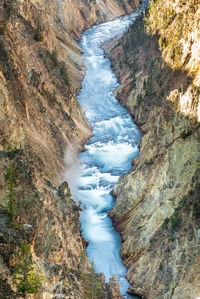 High angle view of waterfall amidst rocks